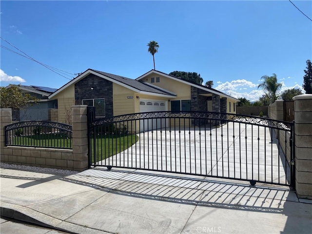 view of gate with a fenced front yard