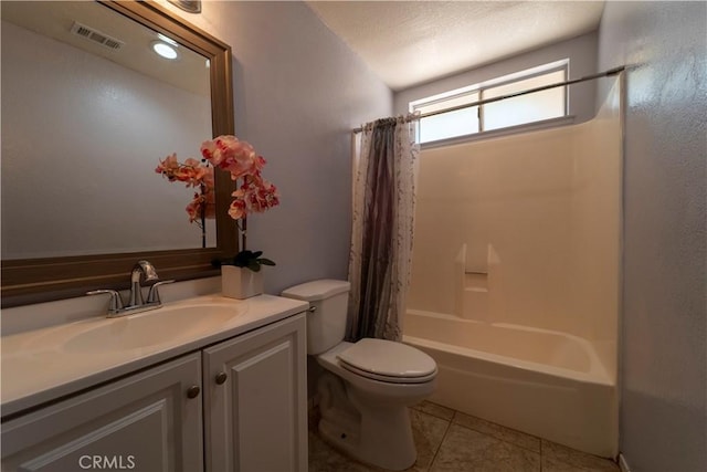 full bathroom with tile patterned floors, toilet, visible vents, shower / tub combo, and vanity