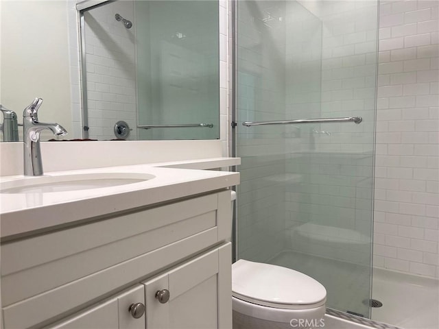 full bathroom featuring vanity, toilet, and a shower stall