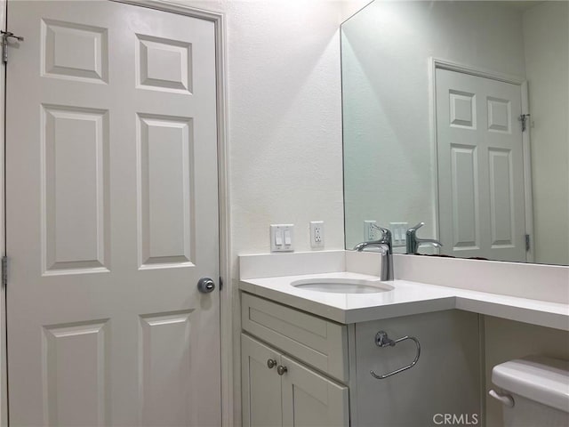 bathroom with toilet and vanity