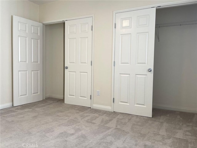 unfurnished bedroom with baseboards and carpet