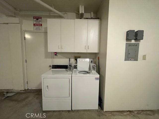 washroom with washer and dryer and cabinet space