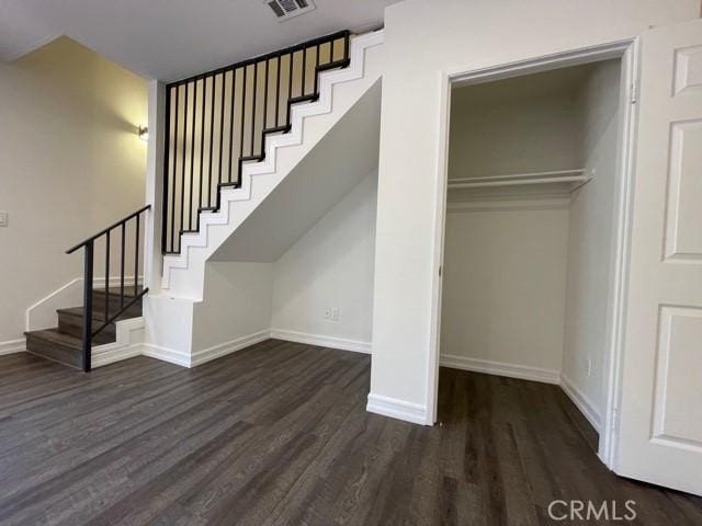 interior space with visible vents, baseboards, and wood finished floors