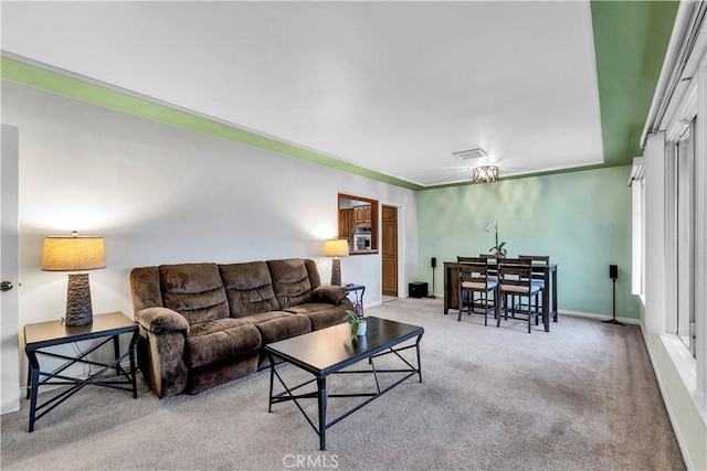 carpeted living room with visible vents and baseboards