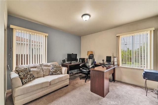 home office featuring light carpet and baseboards