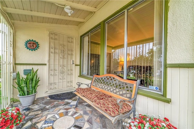 entrance to property featuring board and batten siding and covered porch