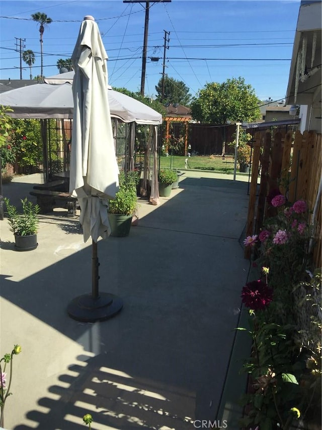 view of patio with a gazebo and fence