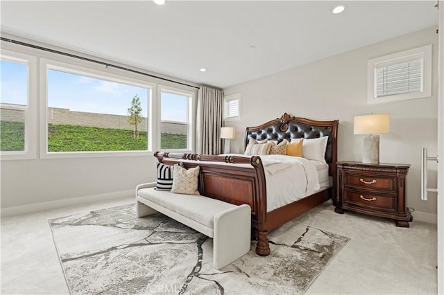 bedroom with recessed lighting, baseboards, and light carpet