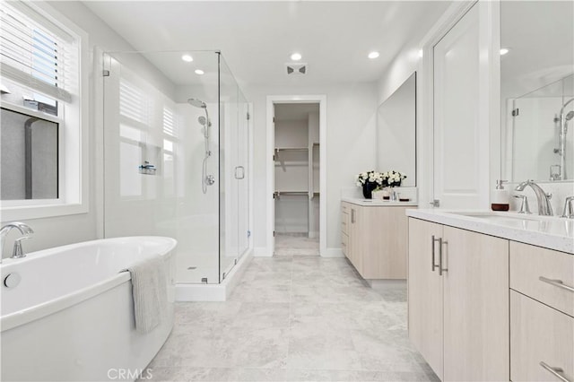 full bath featuring a soaking tub, a stall shower, vanity, and visible vents