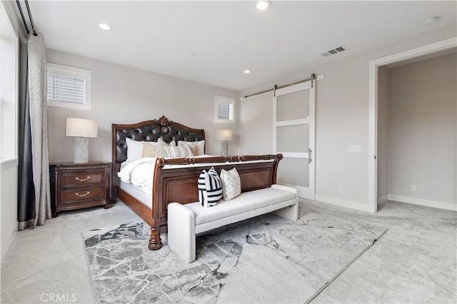 bedroom with baseboards, visible vents, recessed lighting, light carpet, and a barn door