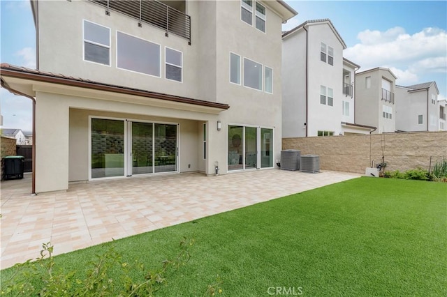 back of property with a patio area, stucco siding, cooling unit, and fence