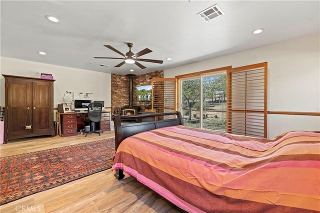 bedroom with access to exterior, recessed lighting, visible vents, and light wood finished floors