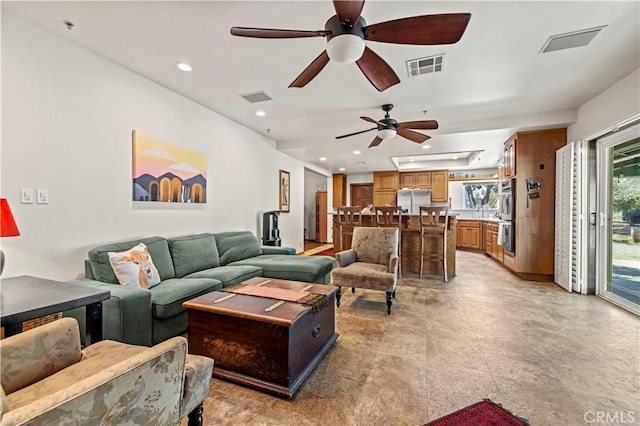 living room featuring visible vents, recessed lighting, and a ceiling fan