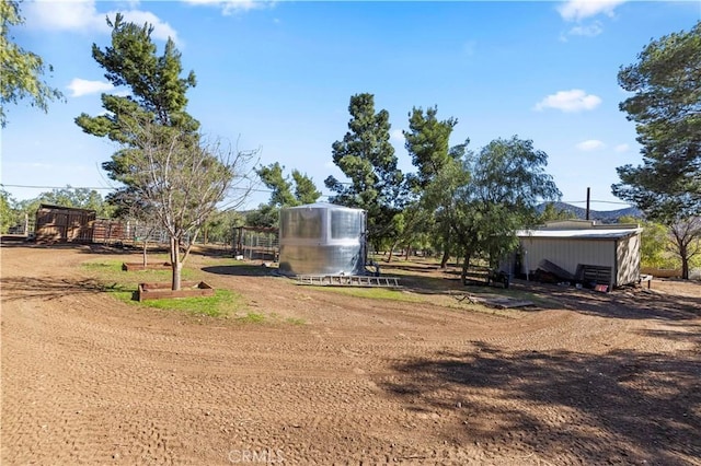 view of yard featuring an outdoor structure and a greenhouse