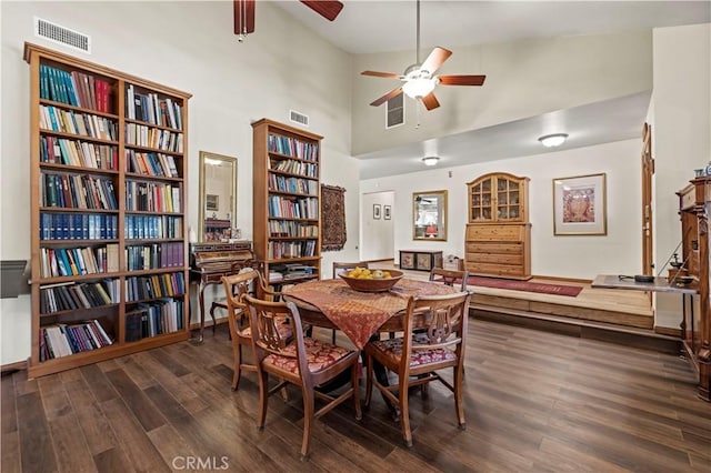 dining area with visible vents, a ceiling fan, and wood finished floors