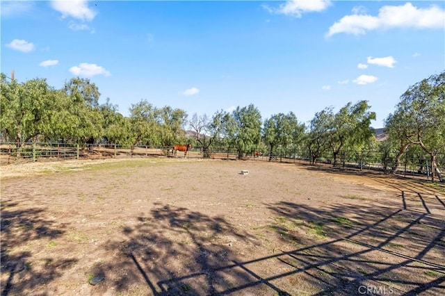 view of yard with a rural view and fence