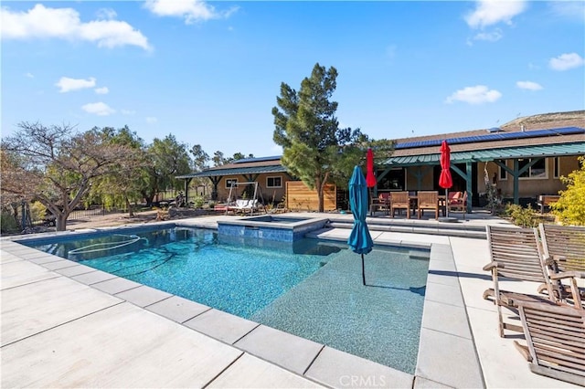 view of swimming pool with outdoor dining area, a patio area, and a pool with connected hot tub