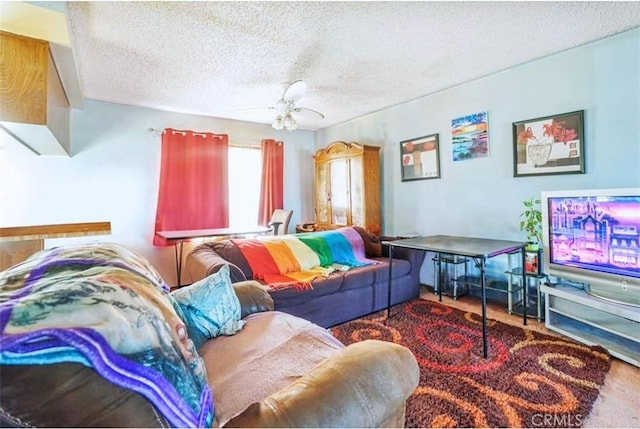 living room with a textured ceiling and ceiling fan