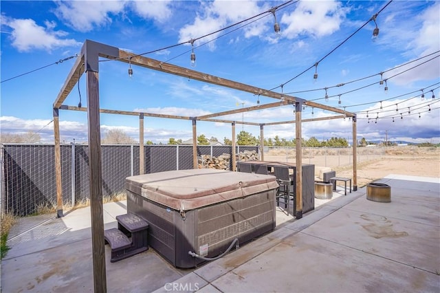 view of patio with a fenced backyard and a hot tub