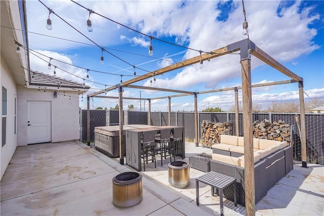 view of patio featuring outdoor dry bar, an outdoor living space with a fire pit, and a fenced backyard