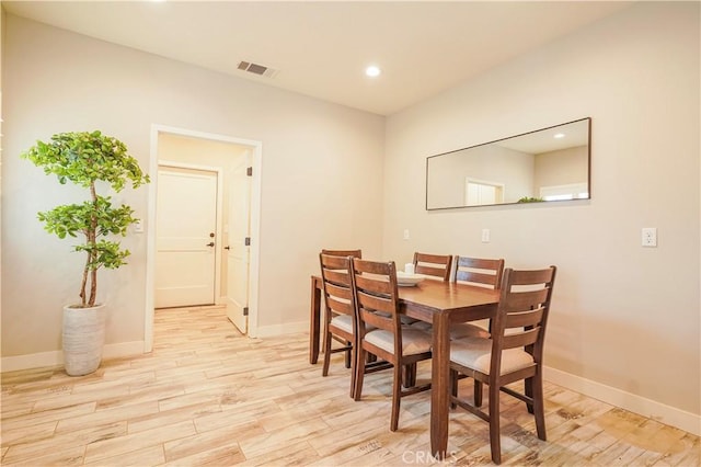 dining space with recessed lighting, baseboards, visible vents, and light wood finished floors