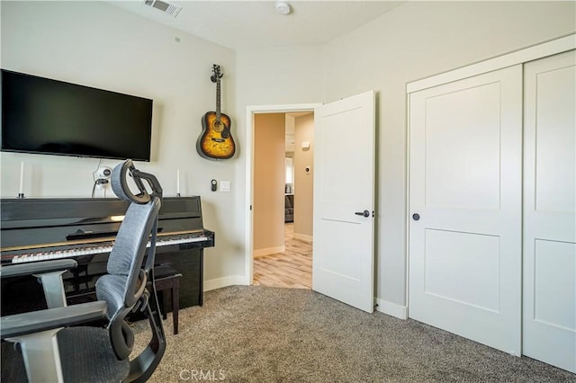 office with visible vents, baseboards, and carpet