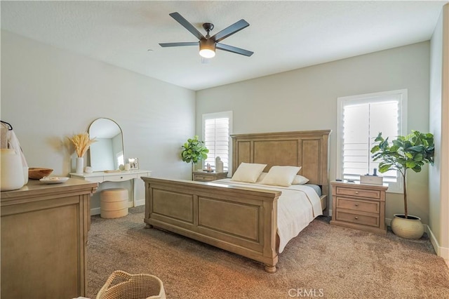 carpeted bedroom with baseboards and a ceiling fan