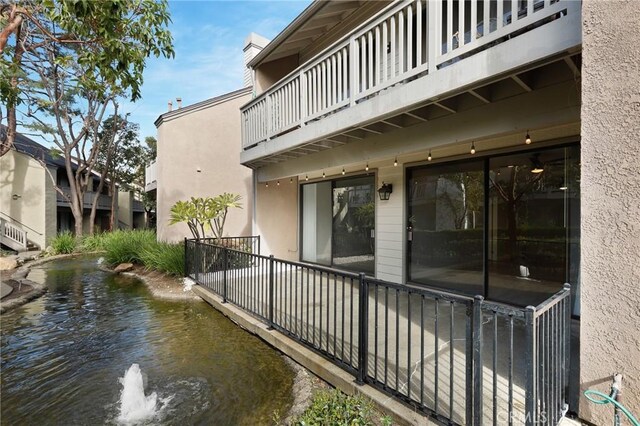 back of property featuring stucco siding