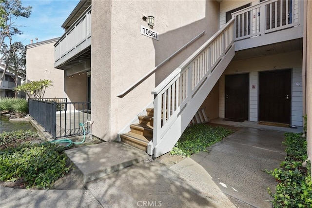 property entrance with stucco siding