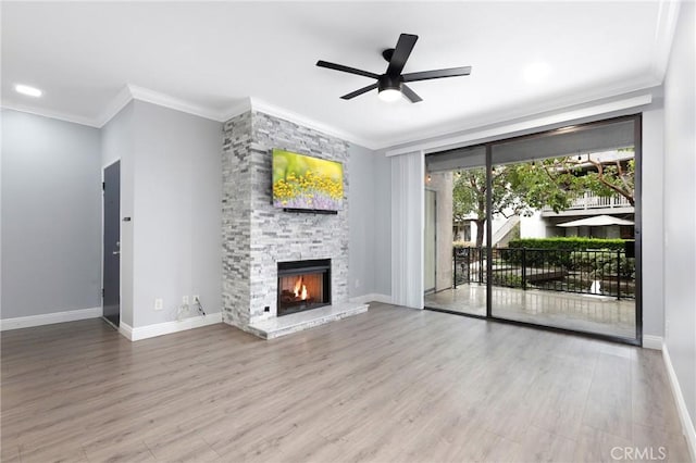 unfurnished living room with a fireplace, crown molding, ceiling fan, and wood finished floors