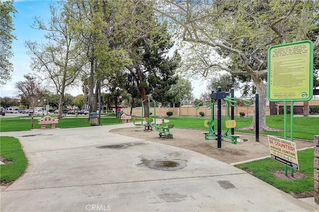 view of property's community featuring a yard and playground community