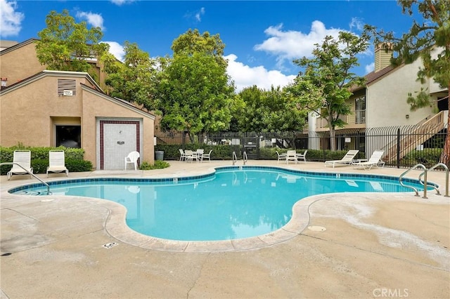 pool featuring a patio and fence