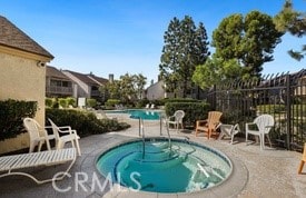 view of pool with a patio area and a hot tub