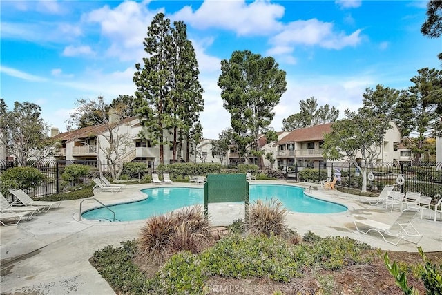 pool featuring a patio area, a residential view, and fence