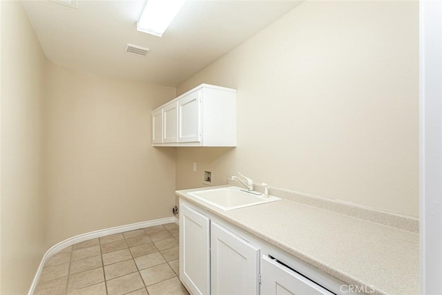 washroom featuring visible vents, washer hookup, light tile patterned floors, cabinet space, and a sink