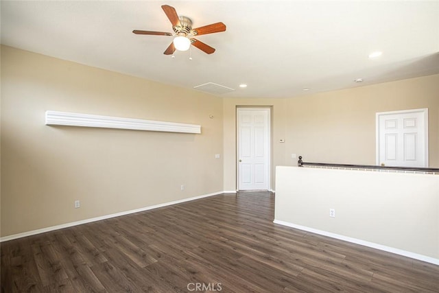 spare room with a ceiling fan, recessed lighting, dark wood-style floors, and baseboards