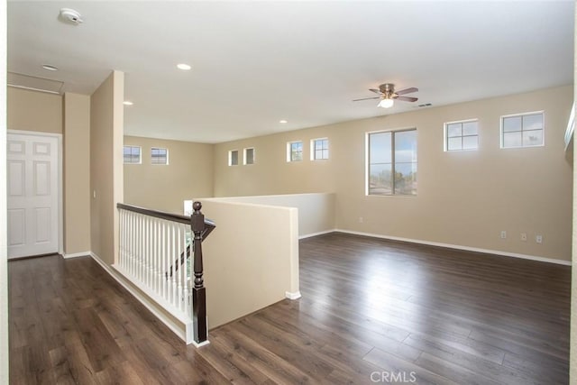 unfurnished room featuring recessed lighting, a ceiling fan, dark wood-style flooring, and baseboards