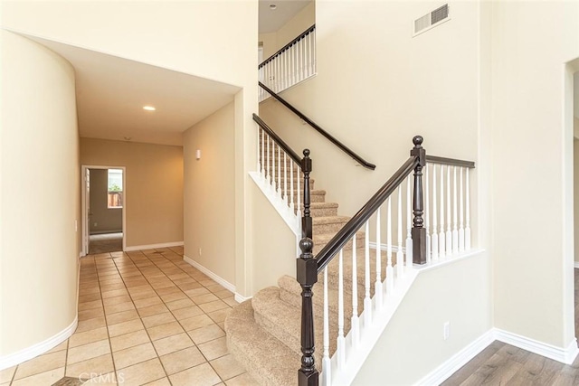 stairs featuring recessed lighting, visible vents, baseboards, and tile patterned flooring