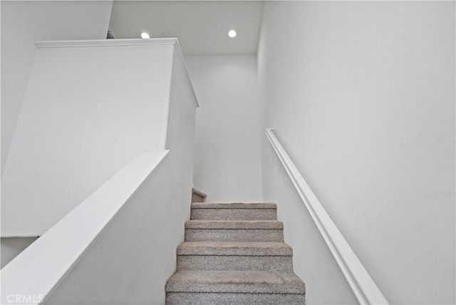 staircase featuring recessed lighting