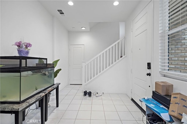 entrance foyer featuring light tile patterned floors, visible vents, recessed lighting, and stairway