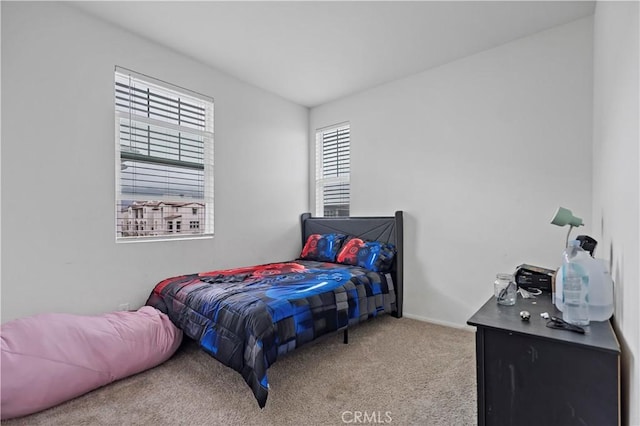 carpeted bedroom with baseboards