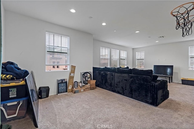 living area with recessed lighting, visible vents, and carpet floors