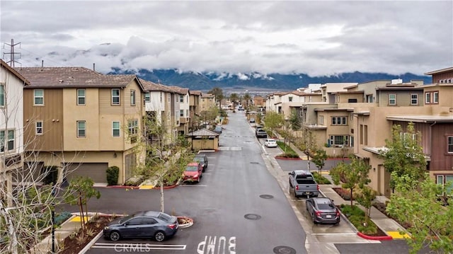 view of road featuring sidewalks, curbs, and a residential view