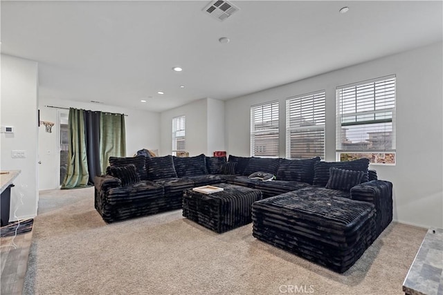 carpeted living room with visible vents and recessed lighting