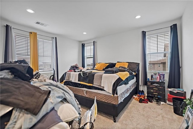 carpeted bedroom with recessed lighting and visible vents