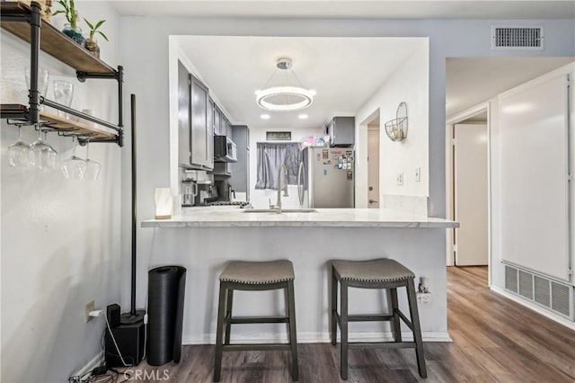 kitchen featuring visible vents, appliances with stainless steel finishes, light countertops, and a sink