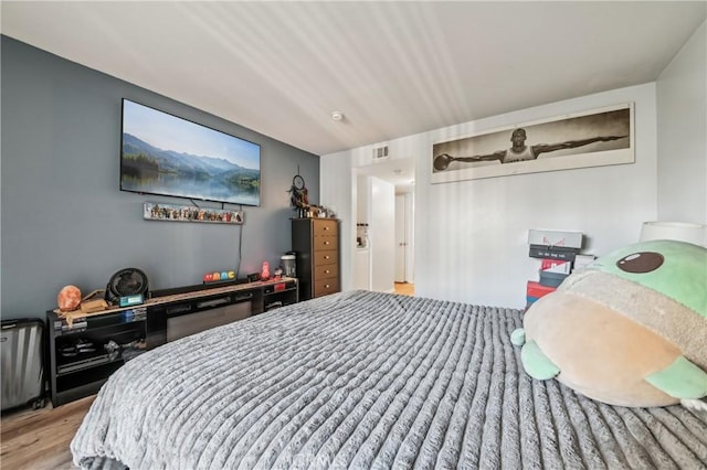 bedroom featuring visible vents and light wood-style flooring