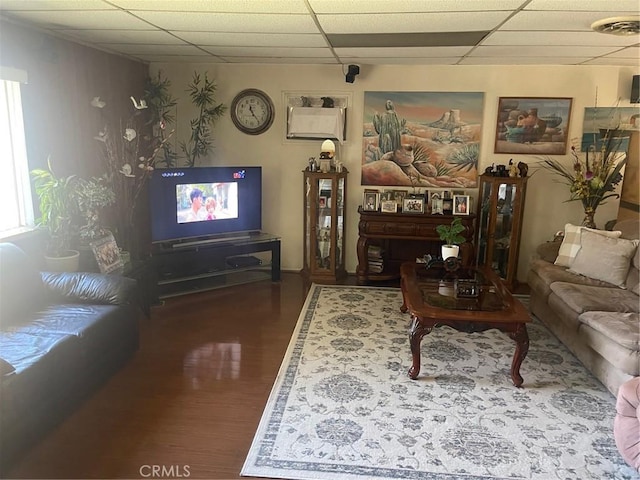 living room featuring visible vents, a paneled ceiling, and wood finished floors