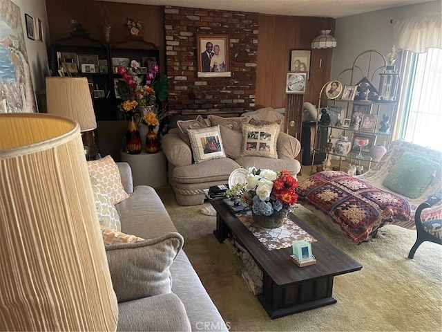 living room featuring carpet and wood walls