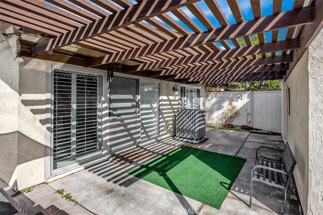 view of patio / terrace with central AC unit, a pergola, and fence